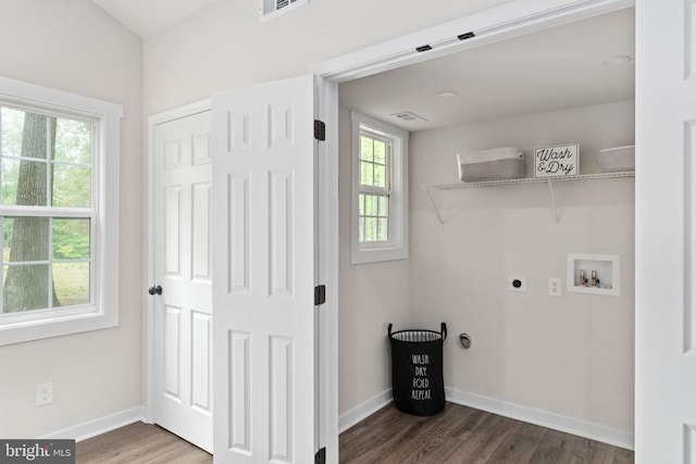 washroom featuring washer hookup, plenty of natural light, wood finished floors, and visible vents