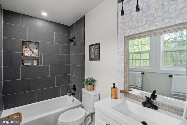 bathroom featuring shower / bath combination, vanity, and toilet
