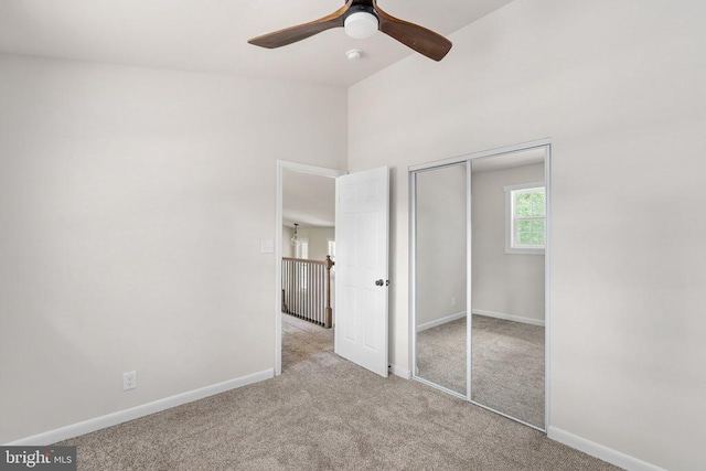 unfurnished bedroom featuring a ceiling fan, baseboards, carpet, and a closet