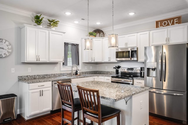 kitchen featuring dark wood-style floors, a sink, appliances with stainless steel finishes, and white cabinetry