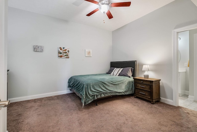 bedroom with baseboards, light carpet, ensuite bath, and ceiling fan