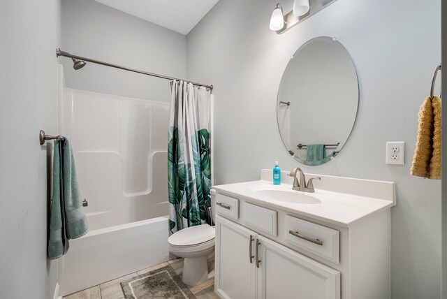 bathroom featuring toilet, shower / bathtub combination with curtain, and vanity