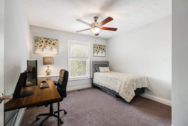 carpeted bedroom featuring a ceiling fan and baseboards