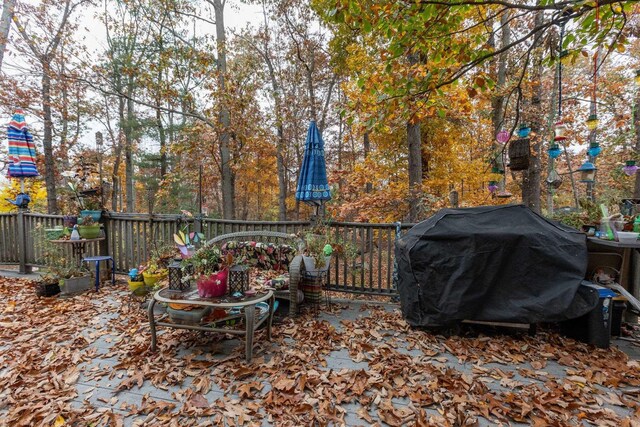 wooden terrace with a grill