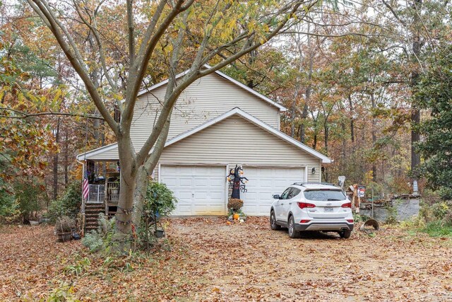 view of property exterior with a garage and a porch