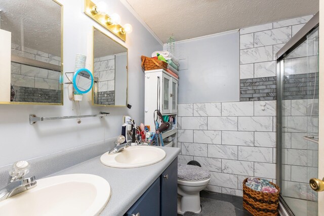 bathroom with a shower with door, tile walls, vanity, a textured ceiling, and toilet