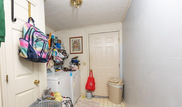 laundry room with washing machine and dryer and a textured ceiling