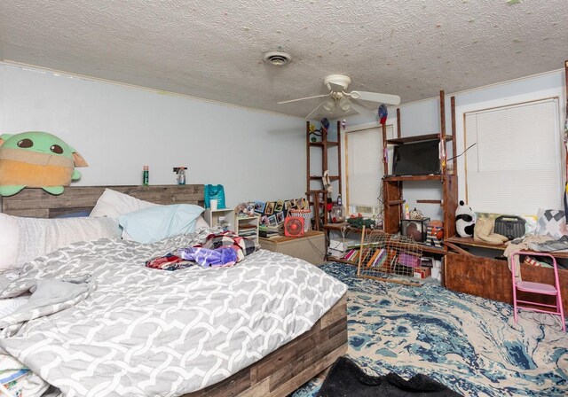 bedroom with ceiling fan, ornamental molding, and a textured ceiling