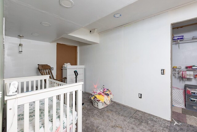 carpeted bedroom with a nursery area