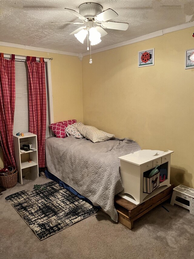 carpeted bedroom featuring crown molding, ceiling fan, and a textured ceiling