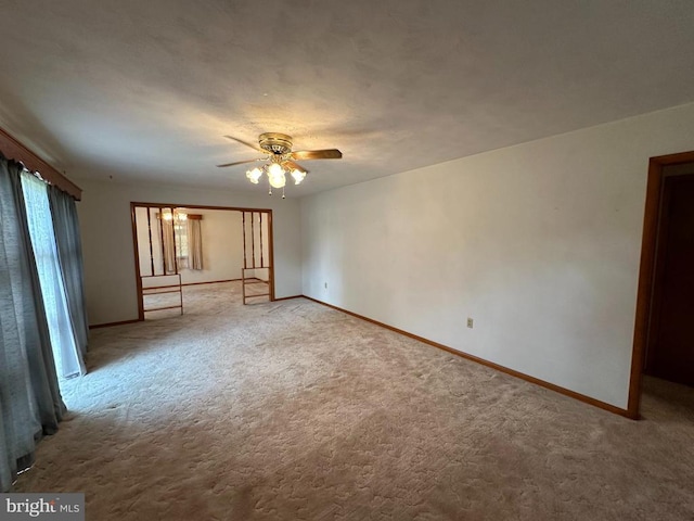 carpeted empty room featuring ceiling fan