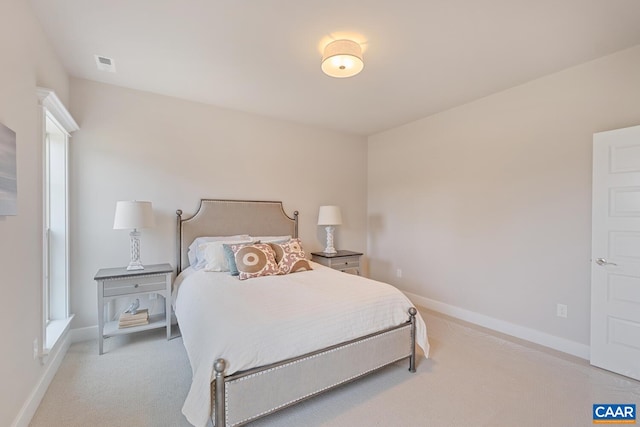 bedroom featuring light colored carpet, visible vents, and baseboards