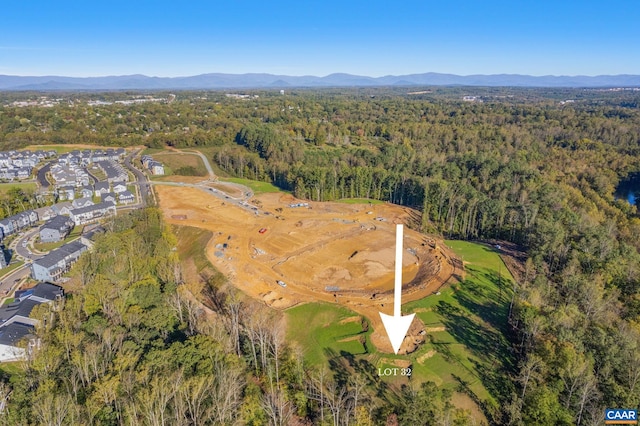 drone / aerial view featuring a mountain view and a wooded view