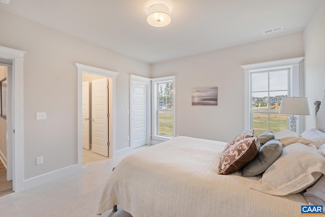 bedroom with carpet, baseboards, multiple windows, and visible vents