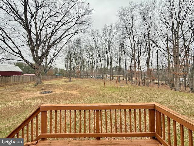 deck featuring a lawn and fence