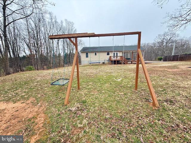 exterior space with a deck and a lawn