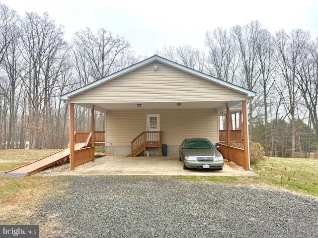 view of front of home with a carport and driveway