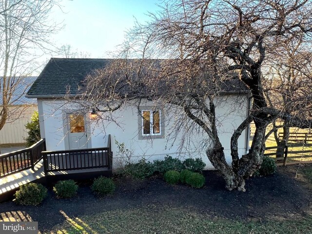 view of side of property featuring a deck