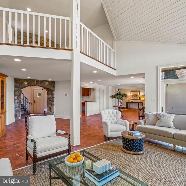 living room with vaulted ceiling with beams, a notable chandelier, and light hardwood / wood-style floors