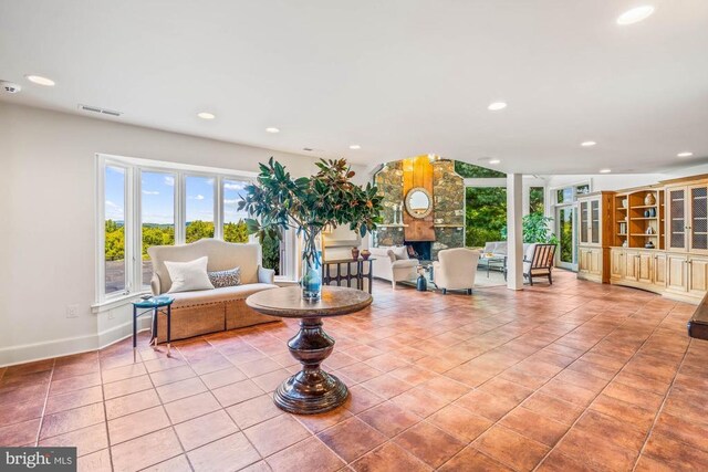 kitchen featuring a spacious island, stainless steel appliances, beam ceiling, and hardwood / wood-style flooring