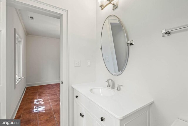 bathroom with crown molding, vanity, and tile patterned flooring