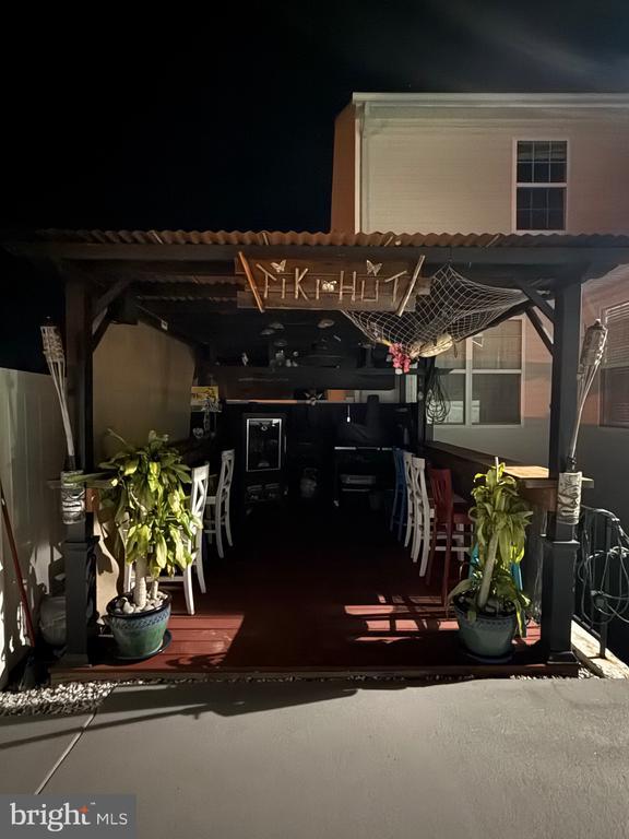 patio at night featuring a pergola