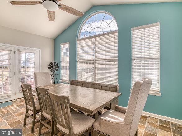 dining room featuring plenty of natural light, lofted ceiling, and ceiling fan