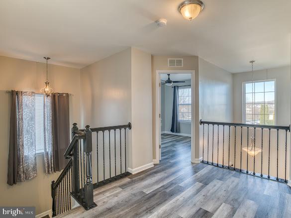 hall with hardwood / wood-style floors