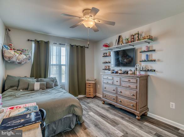 bedroom featuring hardwood / wood-style flooring and ceiling fan