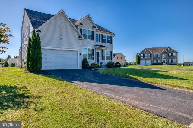 view of front of house featuring a garage and a front lawn