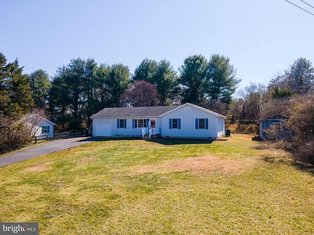 ranch-style house featuring fence, driveway, an attached garage, a front lawn, and crawl space