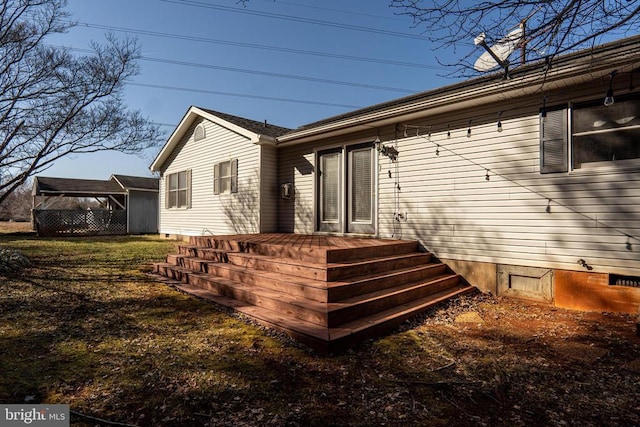 back of house featuring crawl space and a deck