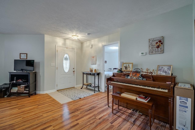 entryway with hardwood / wood-style flooring and a textured ceiling