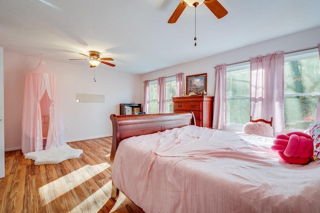 bedroom featuring light hardwood / wood-style floors and ceiling fan