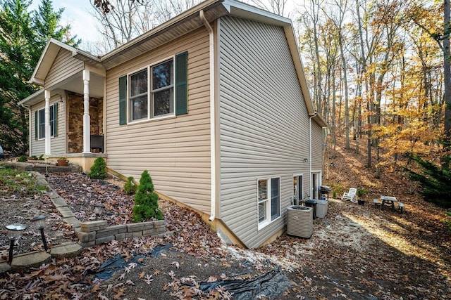 view of side of home with central AC unit