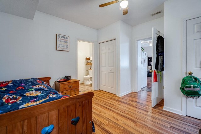 bedroom featuring ensuite bath, ceiling fan, and light wood-type flooring