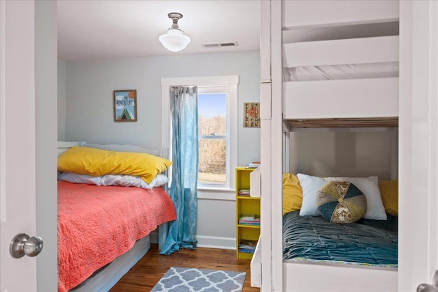 bedroom with dark wood-type flooring, visible vents, and baseboards