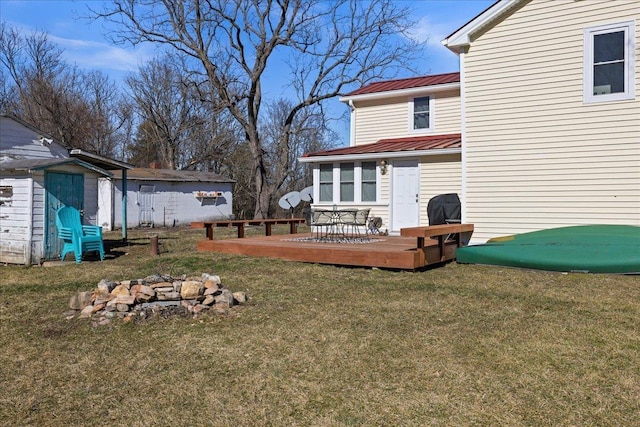 view of yard with an outbuilding, a deck, and a storage unit