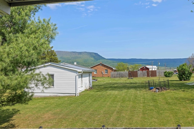 view of yard with a mountain view and fence