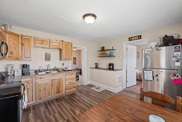 kitchen featuring freestanding refrigerator, light brown cabinetry, range with electric stovetop, a sink, and dark wood finished floors