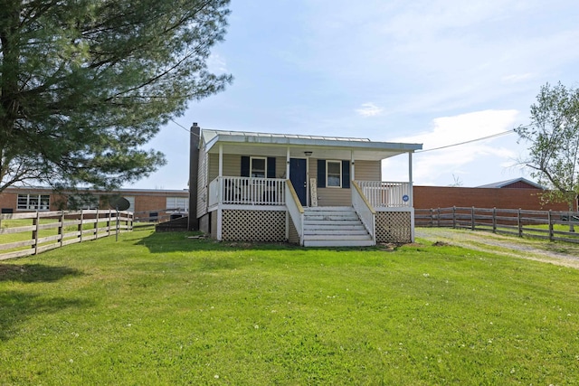 view of front of home with a front lawn, fence, a chimney, a porch, and stairway