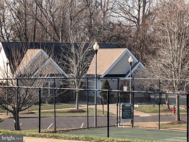 view of sport court featuring fence