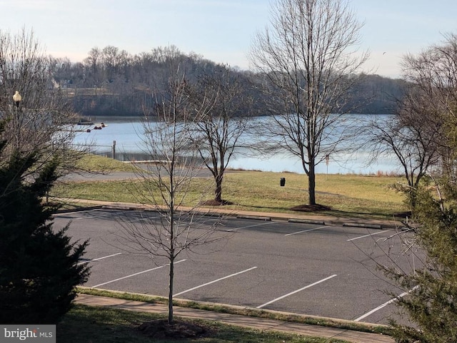 view of tennis court featuring a water view