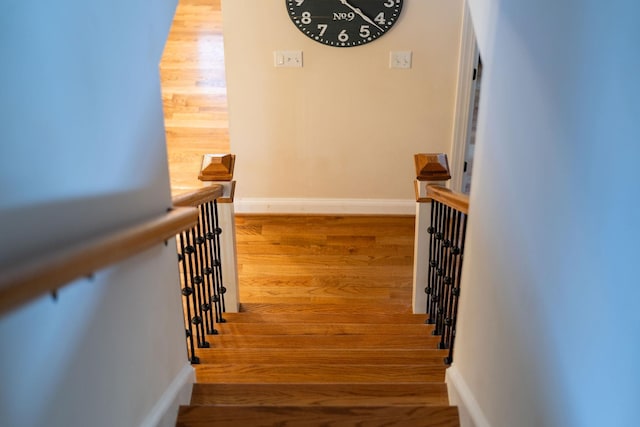 stairs featuring baseboards and wood finished floors