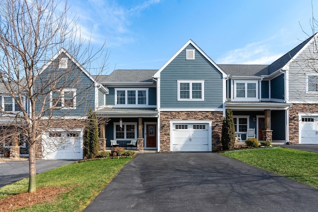 view of front facade with aphalt driveway, stone siding, a porch, a front yard, and an attached garage