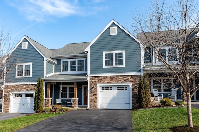 view of front of home featuring a garage, stone siding, a porch, and aphalt driveway