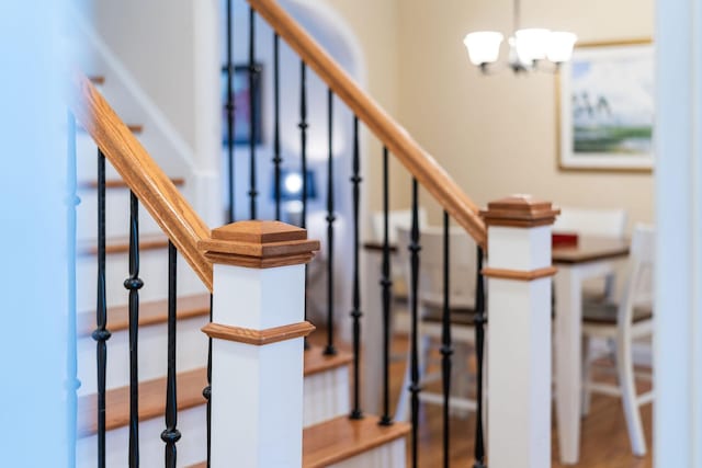 staircase featuring a notable chandelier