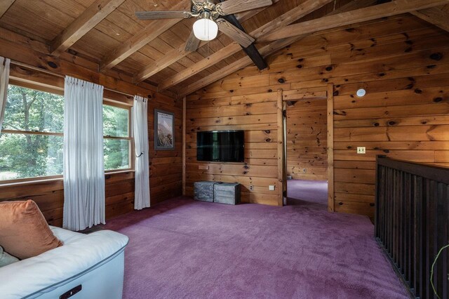 unfurnished room featuring wood ceiling, ceiling fan, vaulted ceiling with beams, carpet, and wood walls