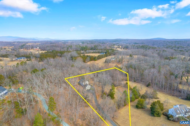 drone / aerial view with a mountain view and a wooded view