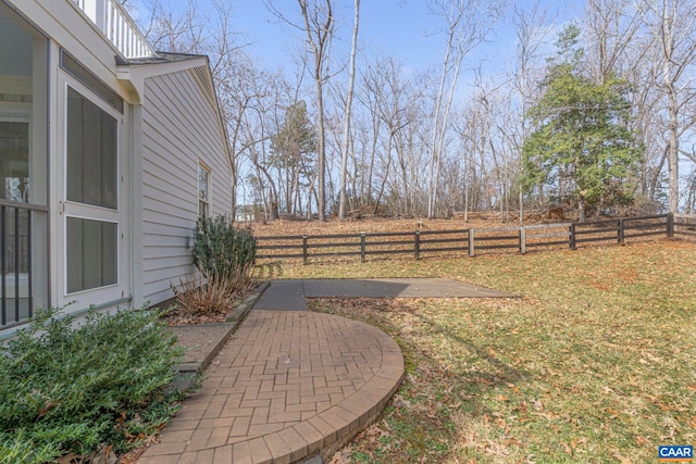 view of yard featuring fence and a patio